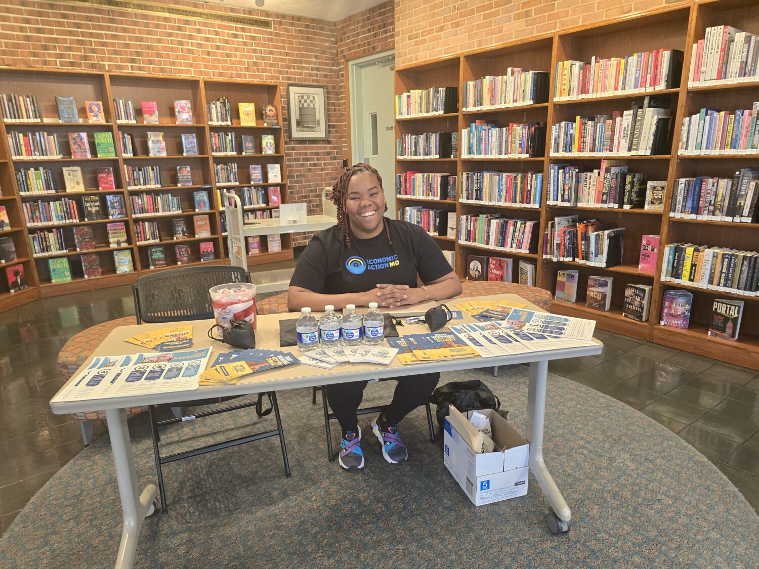 Photo of LaToya McKay tabling at a fair housing outreach event.